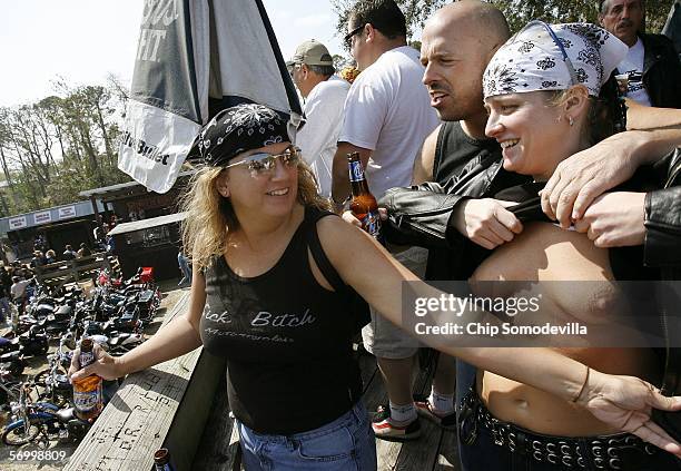 Cold beer and a party atmosphere lends itself to some nudity on the upper deck overlooking hundreds of motocycles at the Iron Horse Saloon during...