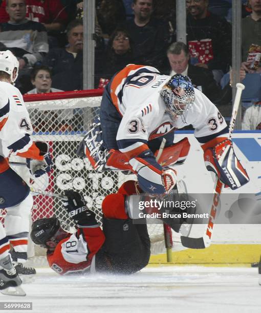 Mike Richards of the Philadelphia Flyers upends Rick DiPietro of the New York Islanders as he crashes into the net on March 4, 2006 at the Nassau...