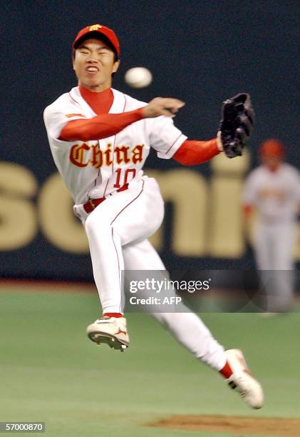 Chinese second baseman Liu Buang-biao jumps in the air as he throws the ball to first base during their World Baseball Classic Asian round against...