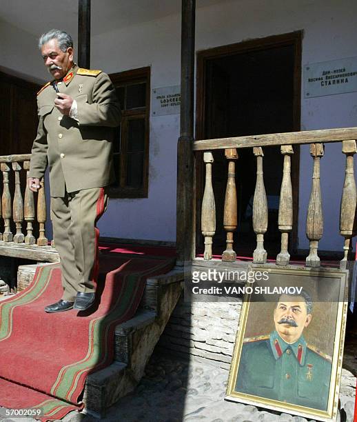 Jamil Ziadaliyev, a double of former Soviet dictator Joseph Stalin, walks out of Stalin's birth house, during celebrations for the 53rd anniversary...