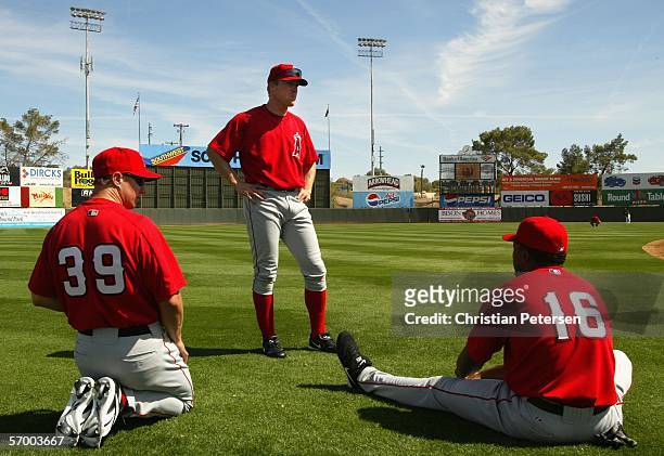 Robb Quinlan, Darin Erstad and Garret Anderson of the Los Angeles Angels of Anaheim warm up on the field before the MLB Spring Training game against...