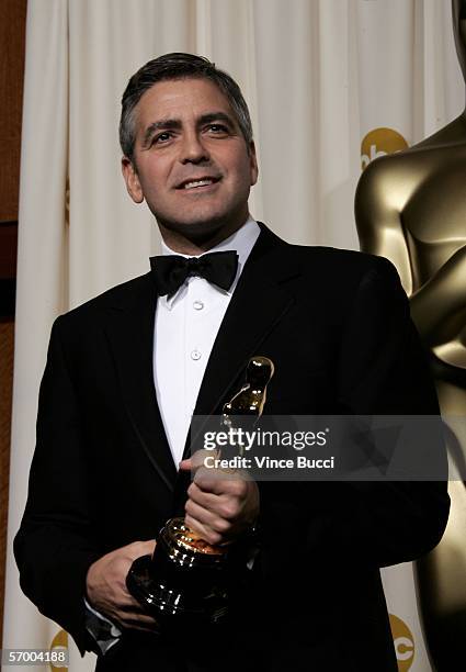 Actor George Clooney poses with his Oscar statuette for "Best Actor in a Supporting Role" for "Syriana" during the 78th Annual Academy Awards at the...
