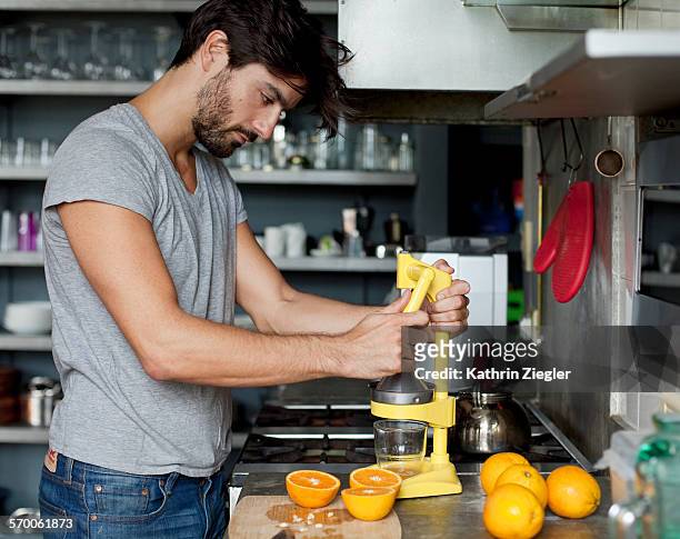 man juicing oranges - juice extractor stock pictures, royalty-free photos & images