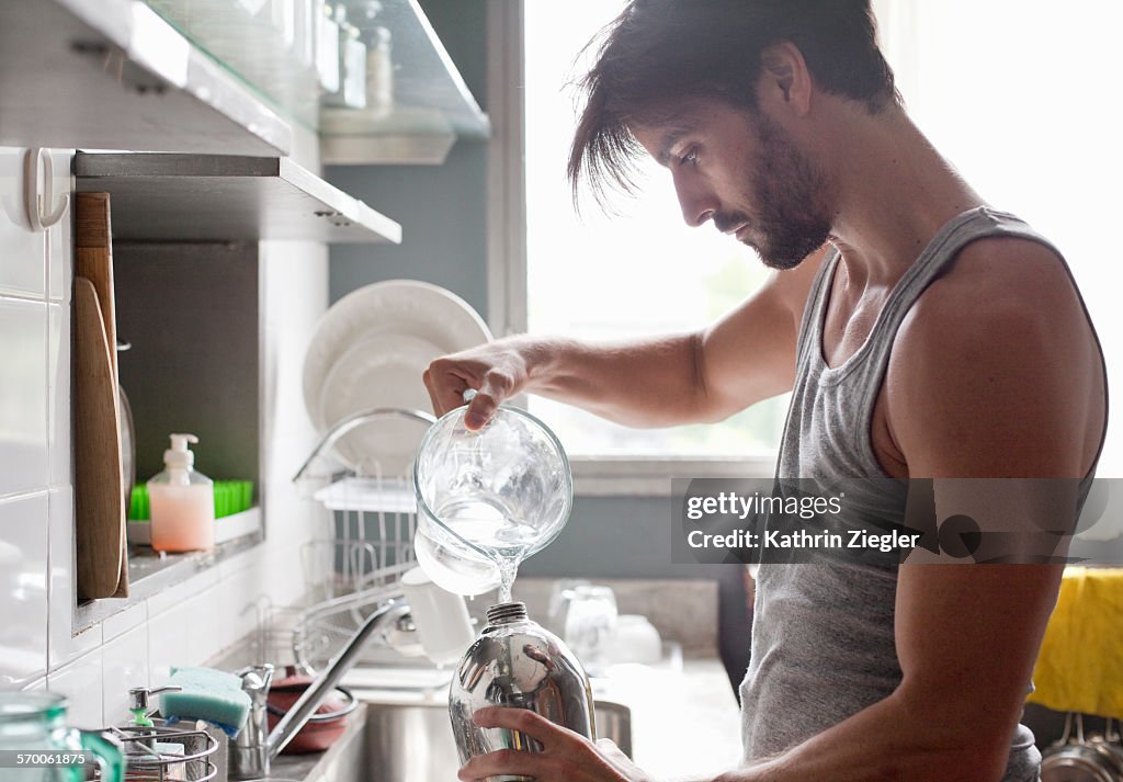 Man filling siphon with water