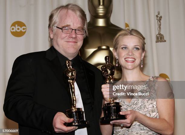 Actor Philip Seymour Hoffman poses with his Oscar statuette for Best Actor in a Leading Role for "Capote" and actress Reese Witherspoon poses with...