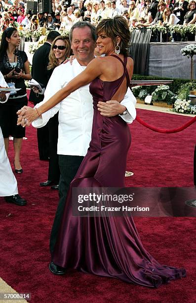 Chef Wolfgang Puck dances with Lisa Rinna as they arrive at the 78th Annual Academy Awards at the Kodak Theatre on March 5, 2006 in Hollywood,...