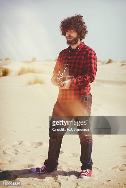man with old movie camera - filmmaker stock pictures, royalty-free photos & images