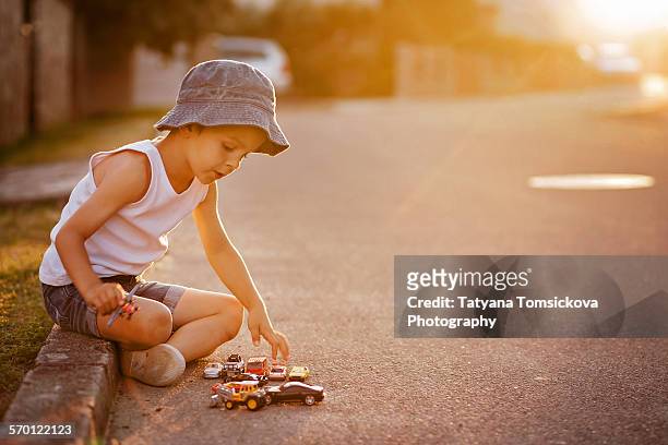 cute little boy, playing with little toy cars - boy playing with cars stock pictures, royalty-free photos & images