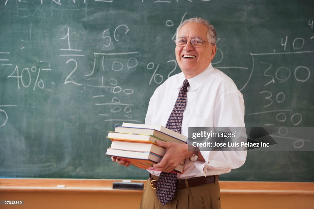 Teacher holding a stack of books