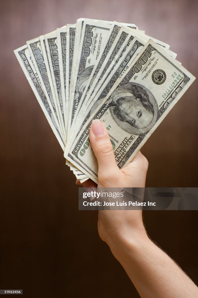 Woman holding fanned out money