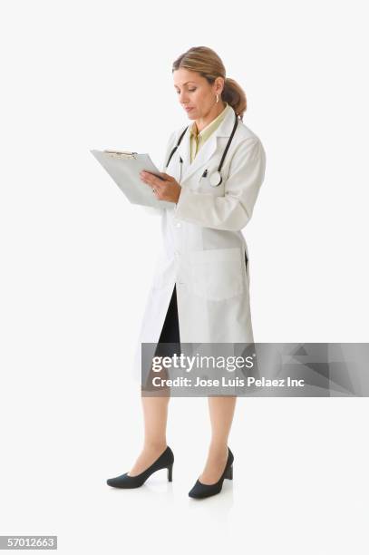 female doctor writing on a clipboard - female doctor on white stock pictures, royalty-free photos & images