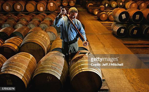 Worker at Bruichladdich distillery takes a whisky sample from a cask March 6 Bruichladdich in Islay. Bruichladdich will use an ancient recipe to...