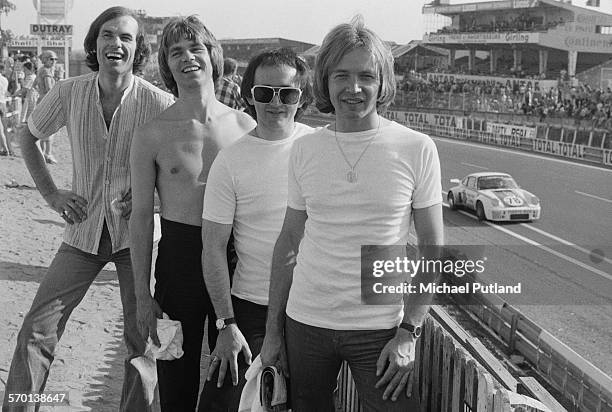 Members of English pop group The Rubettes, at the 24 Hours of Le Mans, France, 12th-13th June 1976. Left to right: bassist Mick Clarke, drummer John...