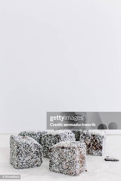 coconut covered lamingtons - lamington cake stock pictures, royalty-free photos & images
