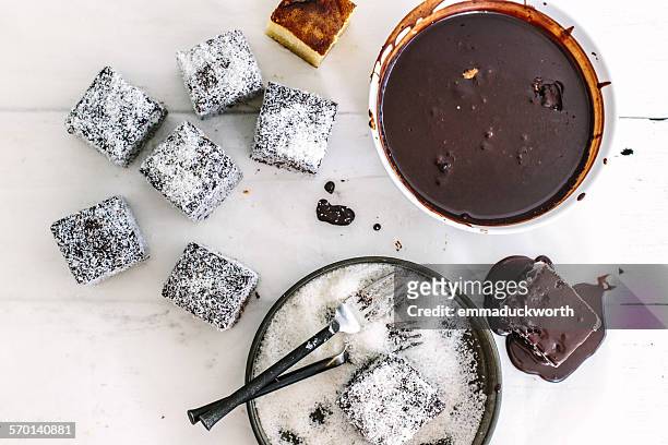chocolate lamingtons in the making - lamington cake stock pictures, royalty-free photos & images