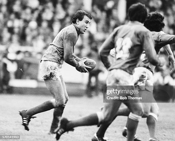 French international rugby player Jean-Luc Joinel passes the ball during a rugby union match, circa 1978.