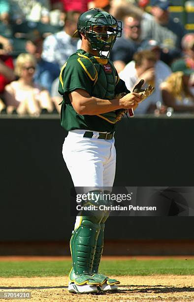 Catcher Jason Kendall of the Oakland Athletics in action against the Los Angeles Angels of Anaheim during the MLB Spring Training game at Phoenix...