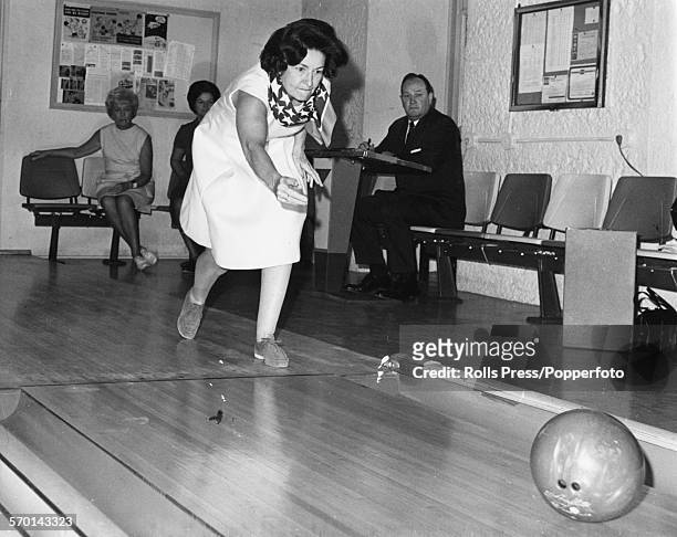 Lady Bird Johnson, wife of former United States President Lyndon B Johnson, pictured enjoying a game of ten pin bowling following her husband leaving...