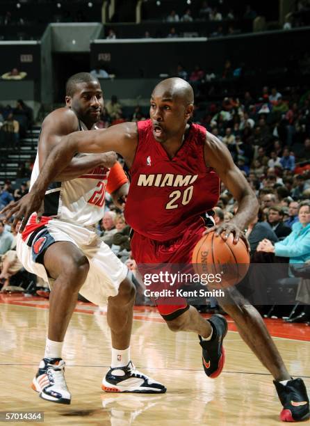 Gary Payton of the Miami Heat drives against Raymond Felton of the Charlotte Bobcats March 6, 2006 at the Charlotte Bobcats Arena in Charlotte, North...