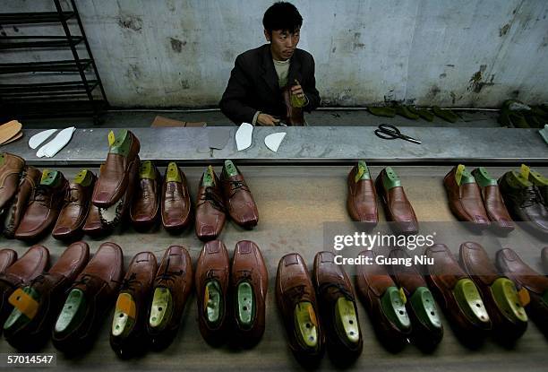 Chinese labourer works at a leather shoe workshop on March 4, 2006 in Wenzhou of Zhejiang Province, China. Wenzhou is one of the major shoe...