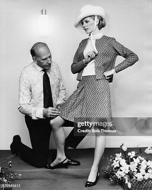 Designer Ted Tinling dresses model Jane Farmer in a New Shetland jersey jacket and skirt suit for the launch of his new collection, April 6th 1967.