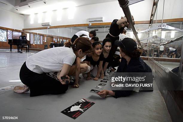 Iraqi Ballet teachers show their ballerinas pictures of professional dancers during a ballet class at the Iraqi school of Music and Ballet, in...