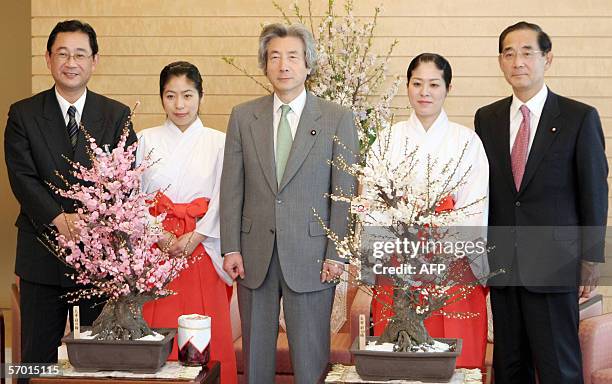 Japanese Prime Minister Junichiro Koizumi poses with representatives of the Dazaifu Tenmangu shrine during their visit at the Prime Minister's...