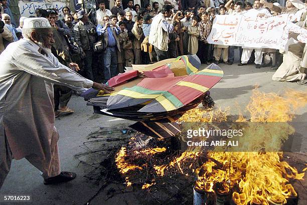 Pakistani protesters burn kites during a protest against the use of metal strings in kite competitions at the Basant festival, in Lahore, 07 March...