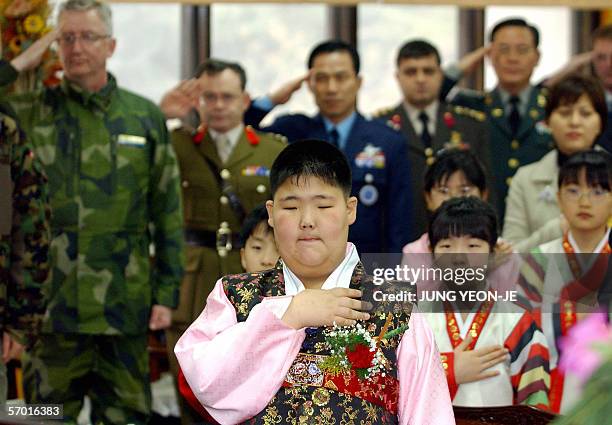 South Korean student from Taesungdong Elementary School, Koo Je-Won , salutes the national flag during his graduation ceremony in Taesungdong freedom...