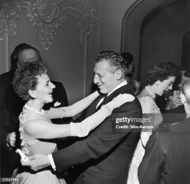 Actress Mary Martin hugs a guest at a party held in her honour at the St Regis Hotel, New York, to celebrate the fifth anniversary of the Broadway...