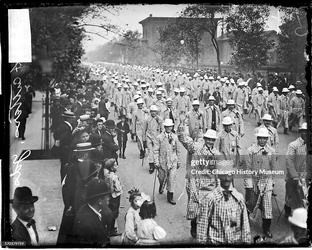 Labor Day parade, meat cutters wearing checkered overcoats marching in parade