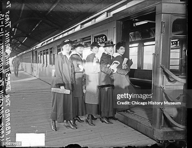 Five women getting on an open-air elevated train car, Chicago, Illinois, November 1, 1915.