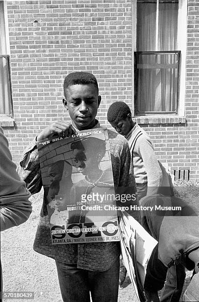 Boy holds up a poster for the Southern Christian Leadership Conference , a nonsectarian American Civil Rights group established by Martin Luther King...