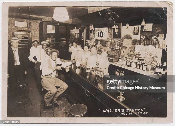 Interior of Walter's Tavern showing owners and family-members behind the bar, Chicago, Illinois, circa 1933. Pictured are, from right to left, Irene...