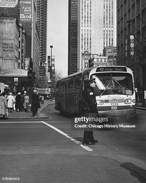 View of an officer directing traffic at State Street and Washington Street, Chicago, Illinois, nineteenth or twentieth century. Chicago Transit...