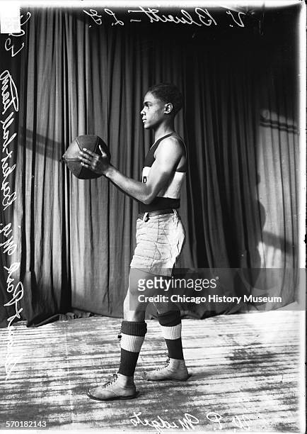 Seward Park basketball player V Blueitt holding a basketball, Chicago, Illinois, 1912.