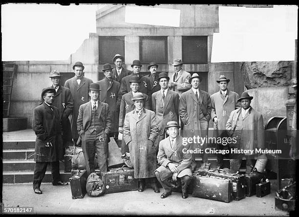 Chicago White Sox baseball players and men associated with the team, wearing suits, standing on a sidewalk and steps in front of a building, Chicago,...