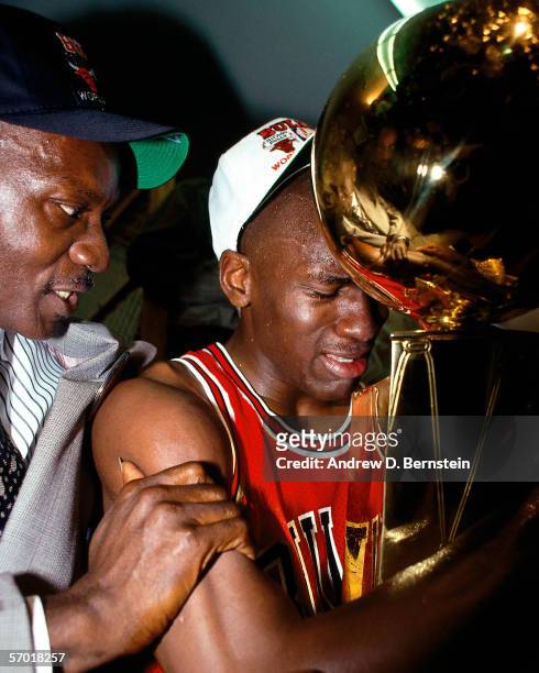 Michael Jordan of the Chicago Bulls celebrates with his father James Jordan in the locker room after winning Game 5 the 1991 NBA Championship Finals...