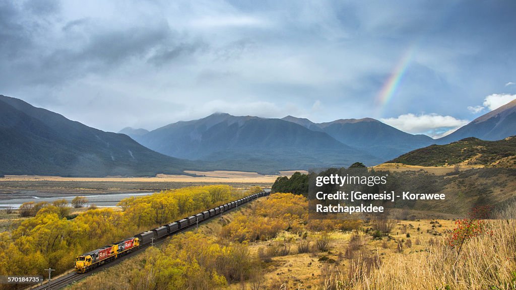 Rural scene with the train and the rainbow