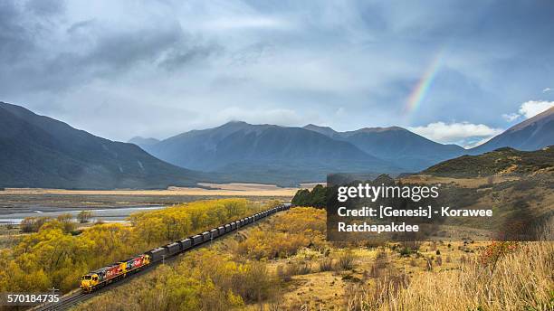 rural scene with the train and the rainbow - christchurch new zealand stock pictures, royalty-free photos & images