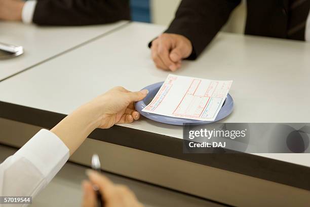 bank counter with teller and customer, close up - bankschalter stock-fotos und bilder