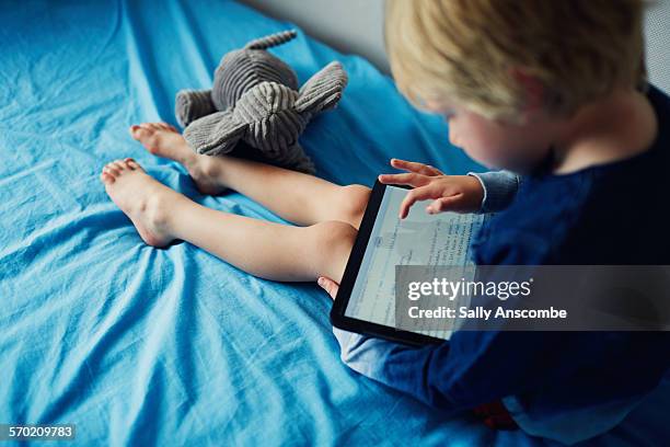 child learning computer programming on a tablet - kids programming stock pictures, royalty-free photos & images