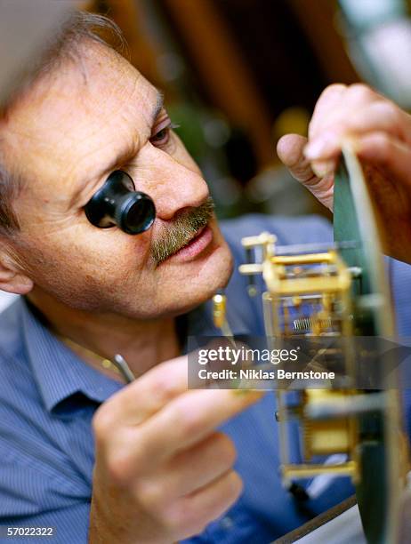 a watchmaker working. - uhrmacher stock-fotos und bilder