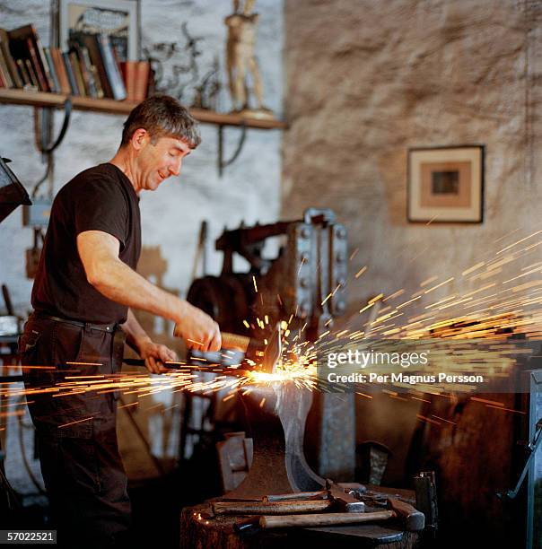 a blacksmith working. - blacksmith sparks stock pictures, royalty-free photos & images