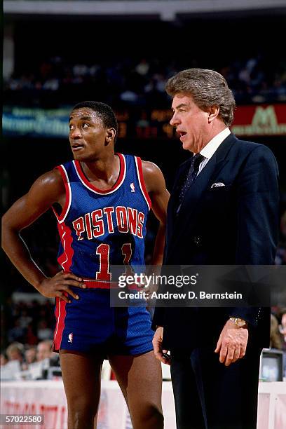 Chuck Daly, head coach of the Detroit Pistons has a few words with Isiah Thomas during a break in the action against the Los Angeles Lakers during a...