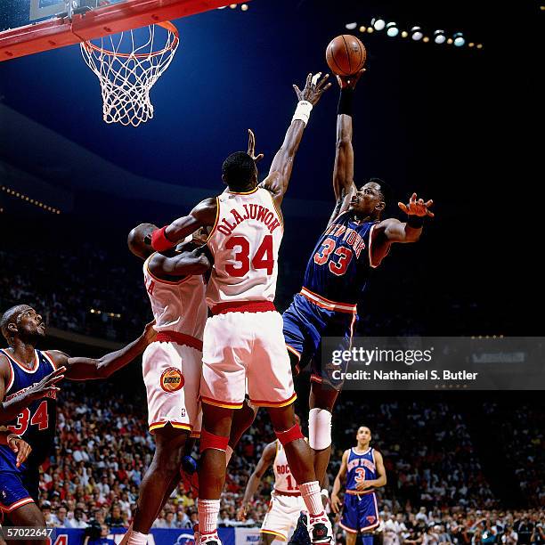 Patrick Ewing of the New York Knicks shoots a hookshot in the paint against Hakeem Olajuwon of the Houston Rockets during a 1994 NBA game at the...