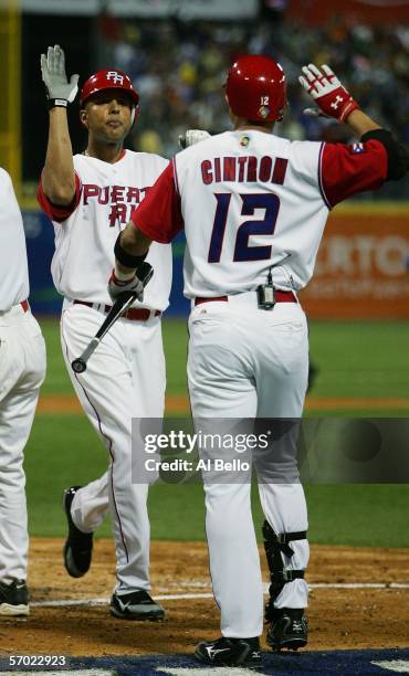 Alexis Rios of Puerto Rico celebrates his home run with Alex Cintron against Panama during their game at the World Baseball Classic at Hiram Bithorn...