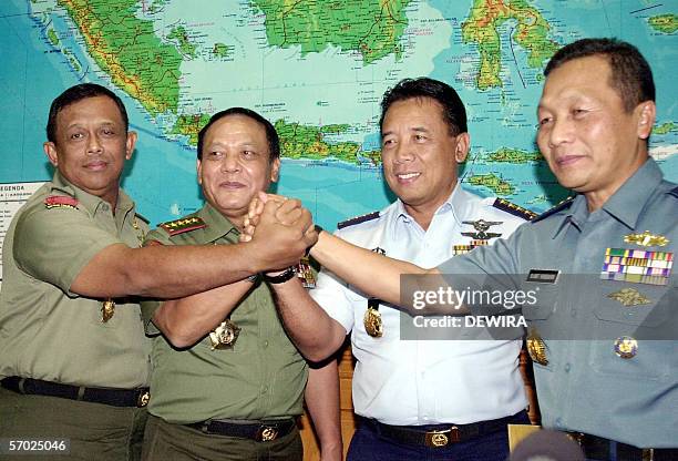 Indonesian outgoing Military Chief, General Endriartono Sutarto join hands with incoming Military Chief Air Marshal Joko Suyanto , Army Chief General...