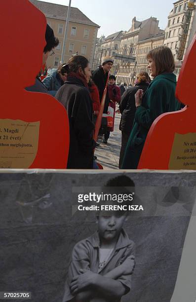 Activists stand in front of red cut-outs of women 08 March 2006 as associations, Amnesty International, "NANE", women's rights assoation, "Habeas...