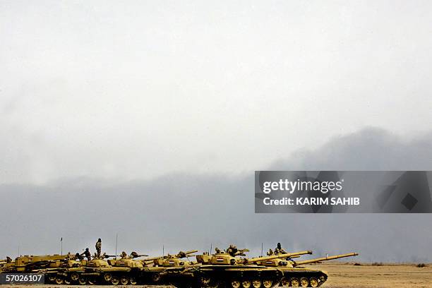 Soviet model T-72 Iraqi tanks from the 9th Army Mechanized Division line up during a training session at the Besmaya range near Taji, northeast of...